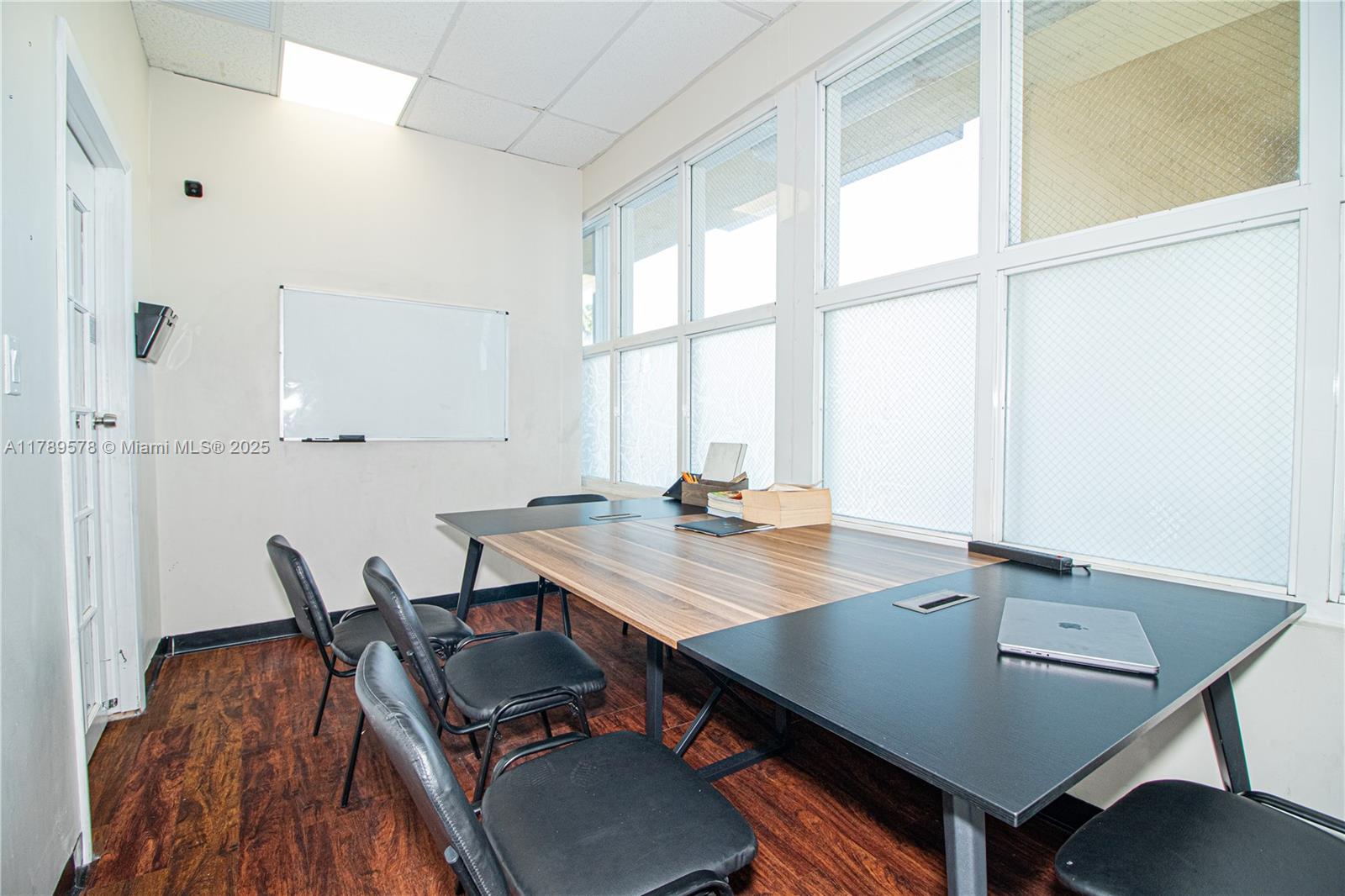 A small office features a long desk, several black chairs, and a wall-mounted whiteboard — 5580 W 16th Ave, Hialeah FL 33012, HIALEAH, FL