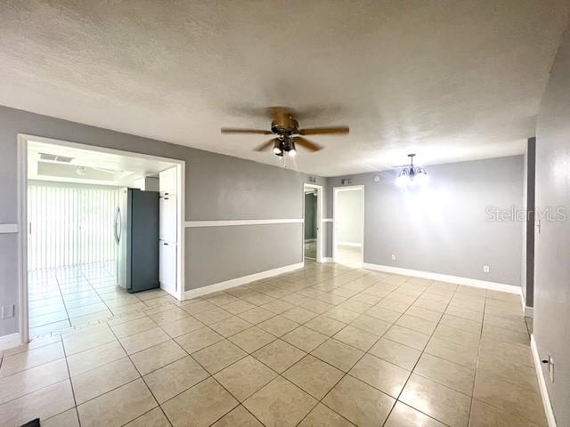 A tiled dining area features a ceiling fan, light fixture, and an adjacent kitchen entrance — 1223 LA MESA AVENUE, WINTER SPRINGS, FL