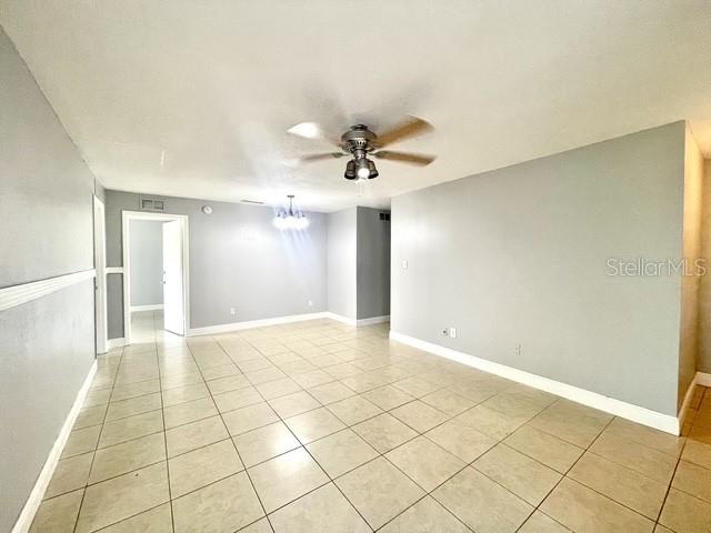 An empty room features light gray walls, a tiled floor, and a ceiling fan — 1223 LA MESA AVENUE, WINTER SPRINGS, FL