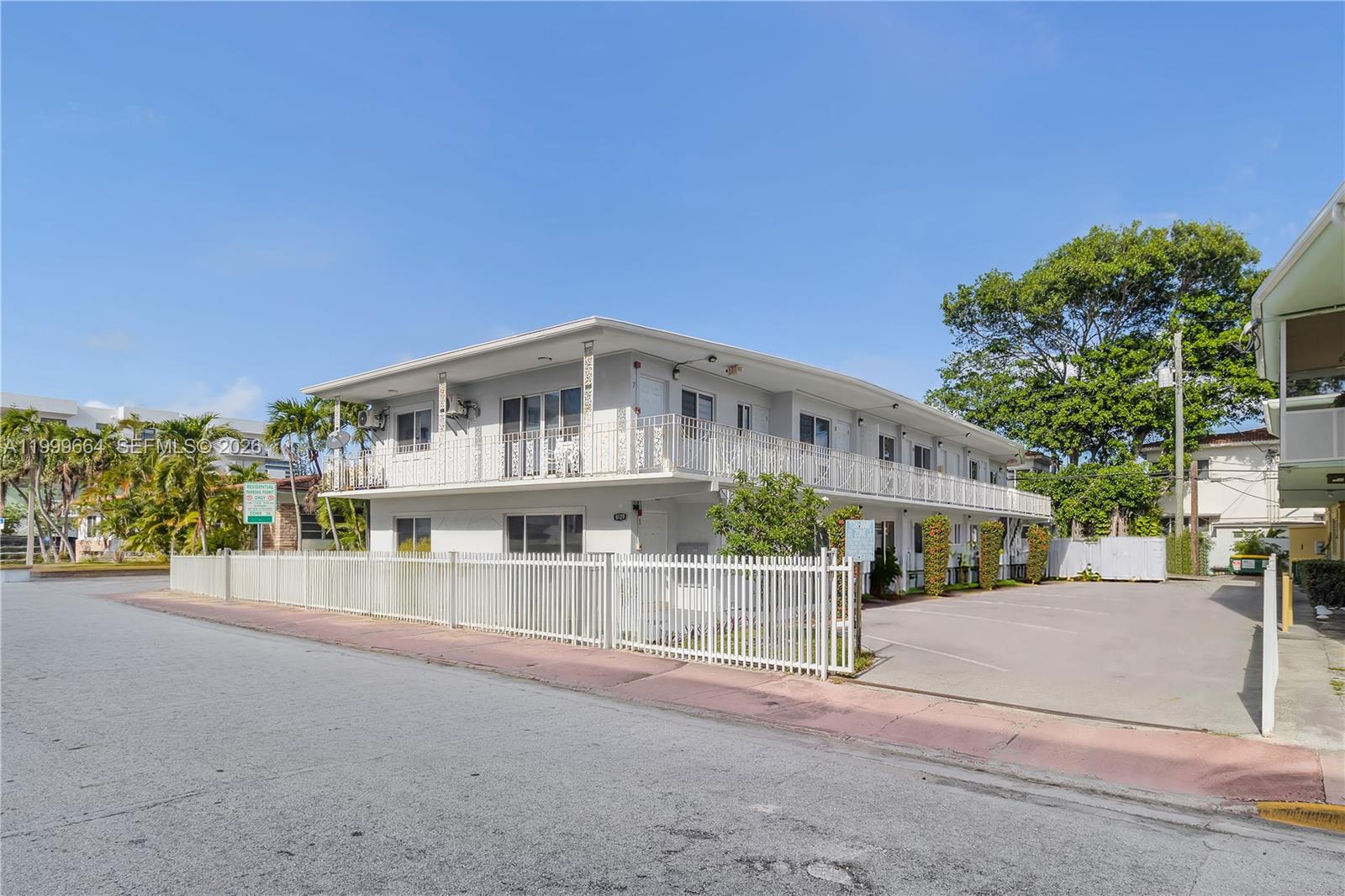 A two-story apartment building with a white fence and a paved parking lot — 8129 Abbott Ave # 10, Miami Beach FL 33141, MIAMI BEACH, FL