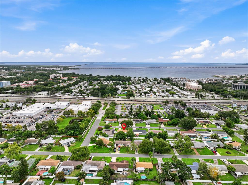 An aerial view shows a residential neighborhood with a red location marker on a house — 1252 BURMA AVENUE, CLEARWATER, FL