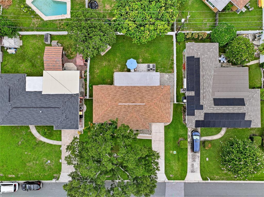 An aerial view shows three residential houses with driveways, lawns, and trees — 1252 BURMA AVENUE, CLEARWATER, FL