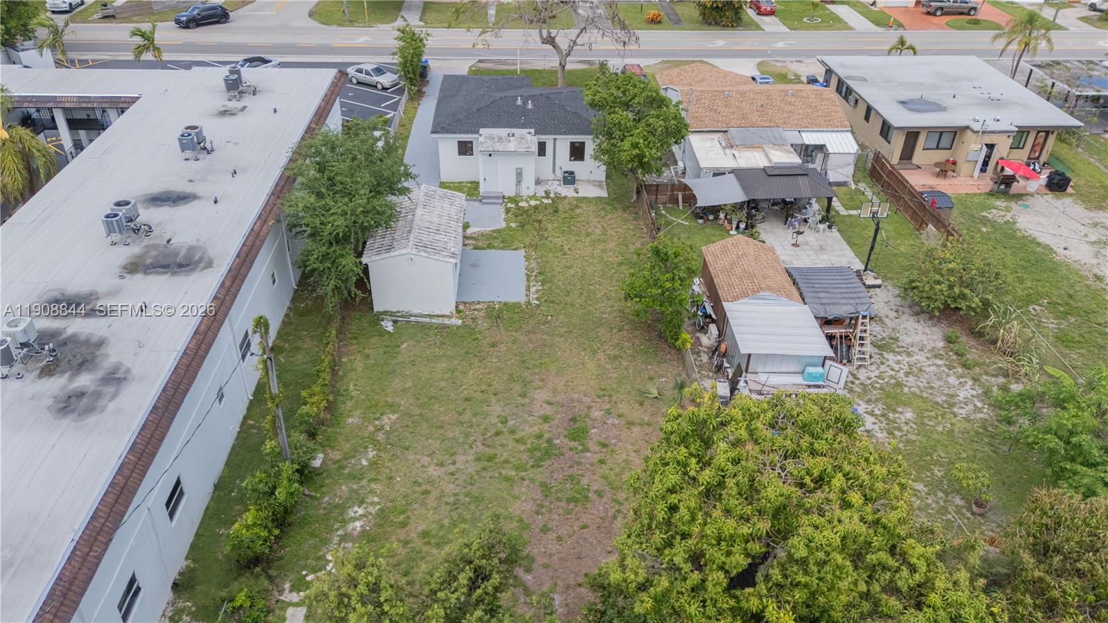 An aerial view shows a residential property with a house, shed, and large backyard — 2462 Johnson St, Hollywood FL 33020, HOLLYWOOD, FL