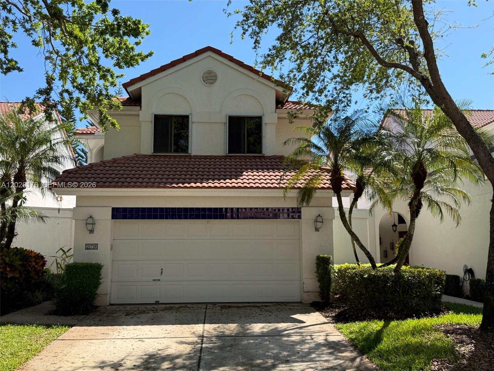 A two-story house with a white stucco facade, a tile roof, and a two-car garage — 21719 Cromwell Cir, Boca Raton FL 33486, BOCA RATON, FL