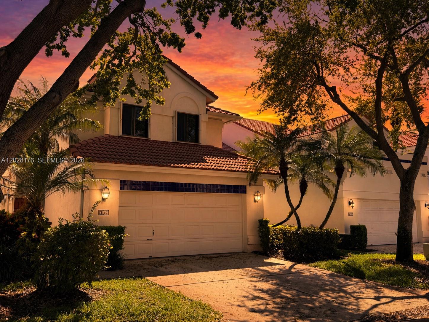 A two-story house with a tile roof and a garage at sunset — 21719 Cromwell Cir, Boca Raton FL 33486, BOCA RATON, FL