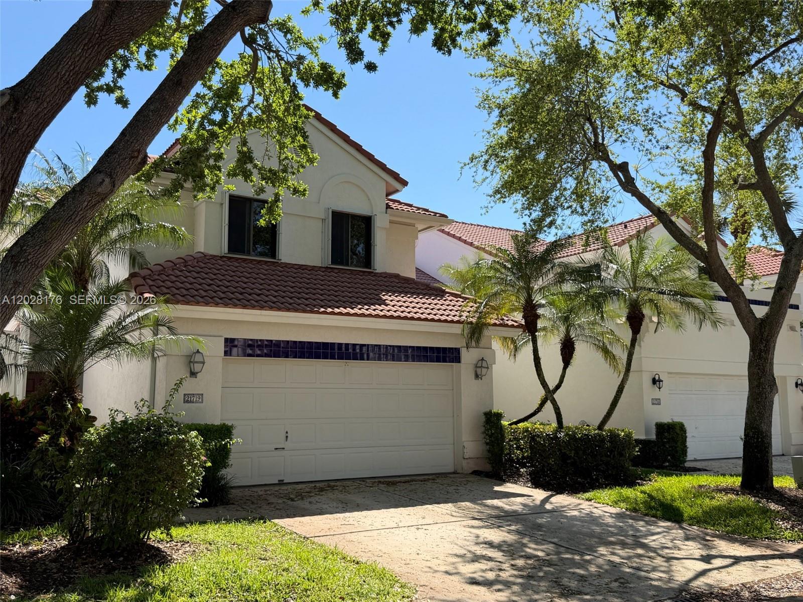 A two-story house with a tile roof, white stucco walls, and a two-car garage — 21719 Cromwell Cir, Boca Raton FL 33486, BOCA RATON, FL