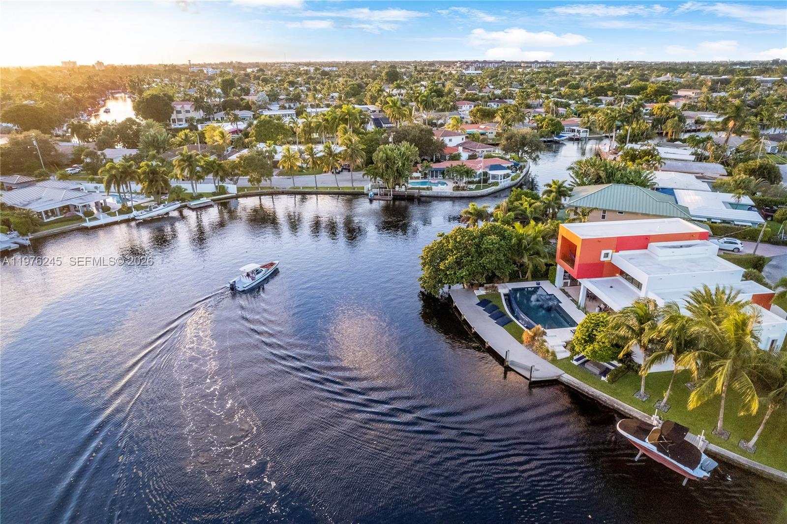 An aerial view shows a modern house with a pool along a canal with boats — 2101 NE 20th Ave, Wilton Manors FL 33305, WILTON MANORS, FL