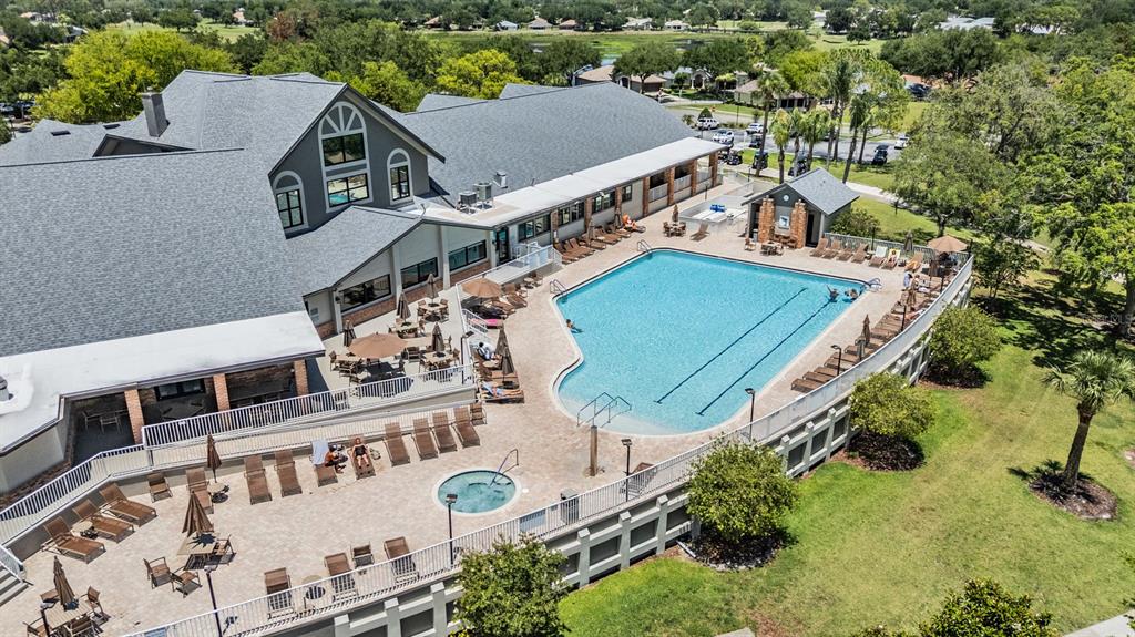 An aerial view shows a large building with a swimming pool and a hot tub — 11709 SPINDRIFT LOOP, HUDSON, FL
