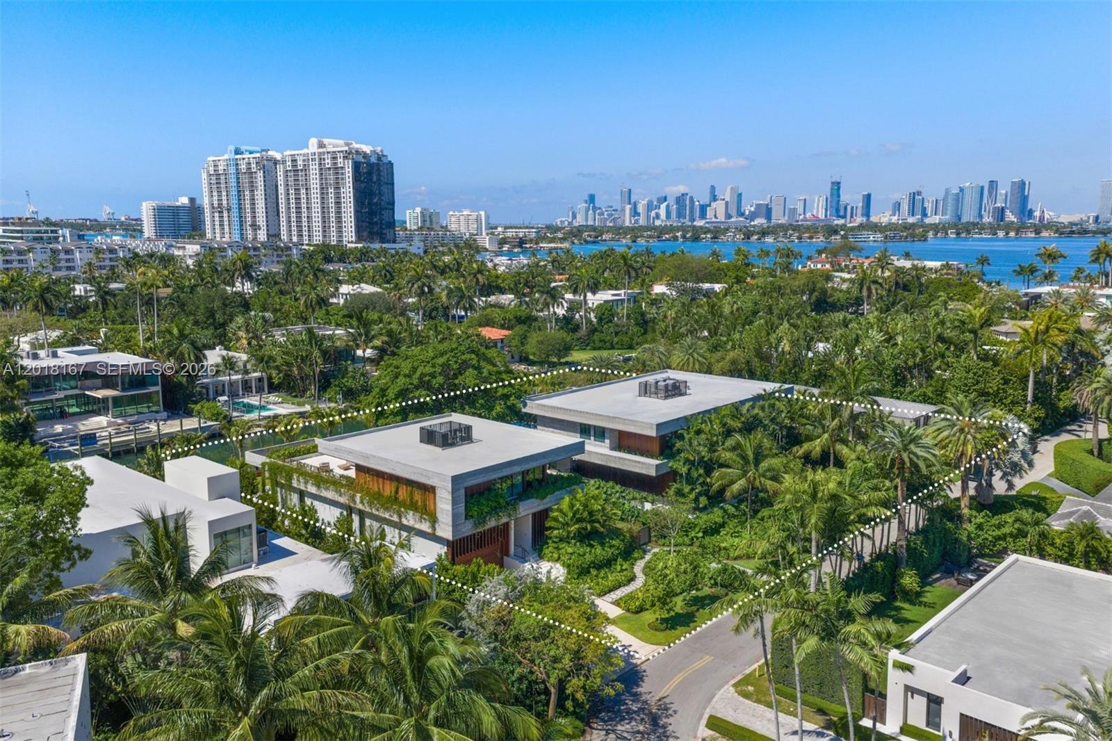 An aerial view shows two modern concrete homes surrounded by lush tropical landscaping and palm trees — 1420 W 23rd St, Miami Beach FL 33140, MIAMI BEACH, FL