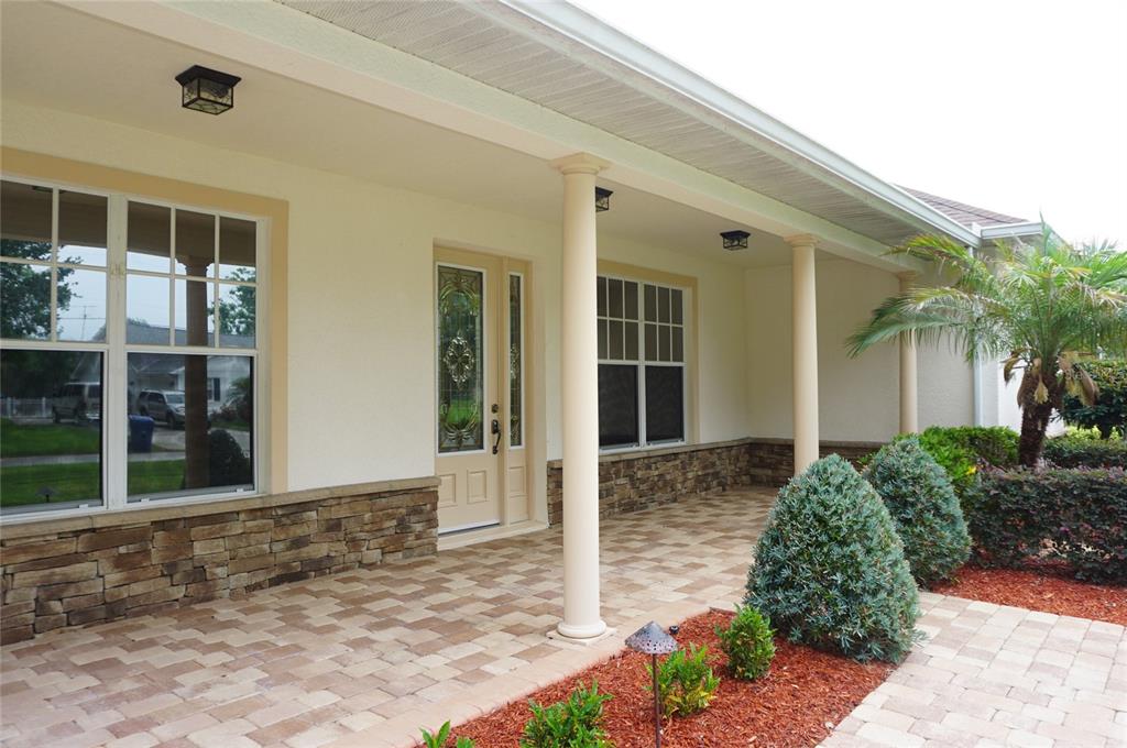 A foyer with hardwood floors, a central chandelier, and a white front door with sidelights — 6402 BARCELLONA ROAD, LAND O LAKES, FL