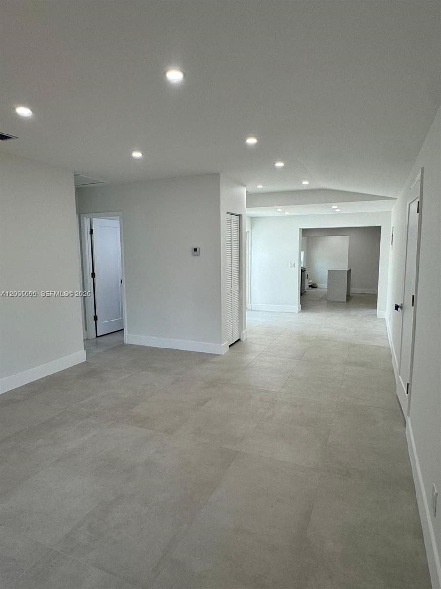 An interior view shows a room with light gray tile flooring and recessed ceiling lighting — 4028 SW 49th Ct, Dania Beach FL 33314, DANIA BEACH, FL
