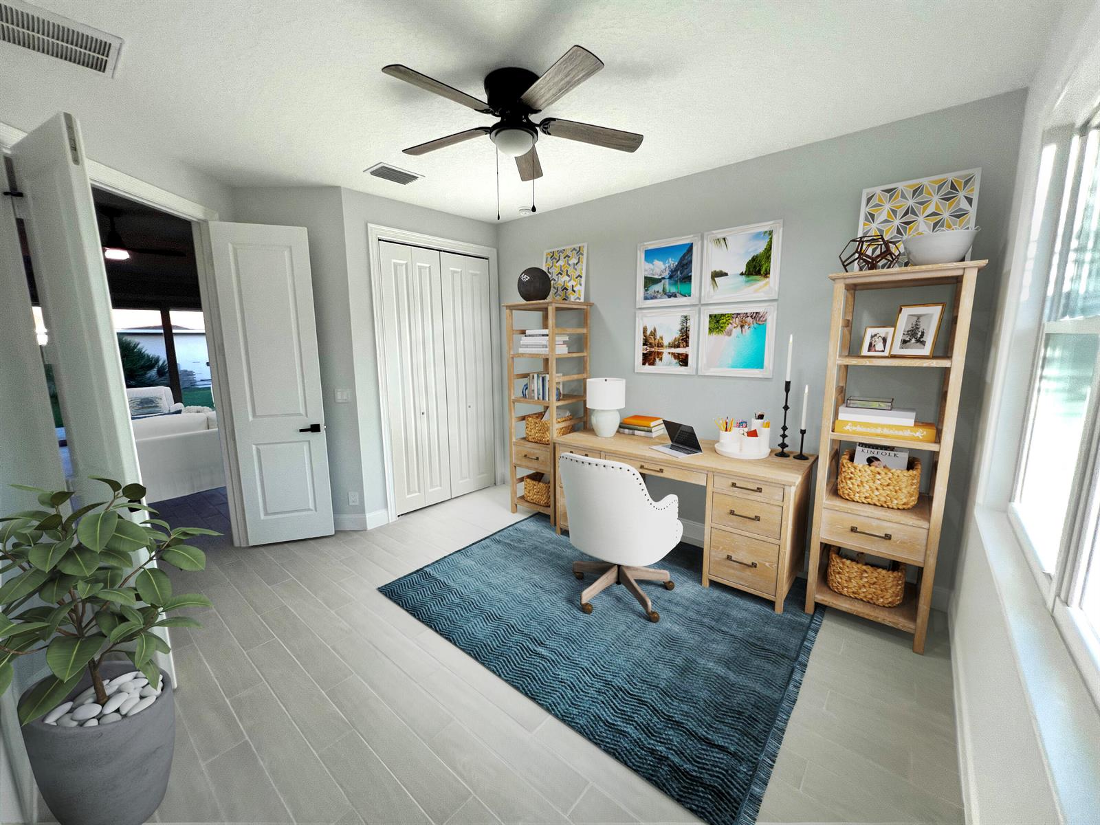 A home office with a wooden desk, two matching bookshelves, and a blue area rug — 6660 49th, Vero Beach FL 32967, VERO BEACH, FL
