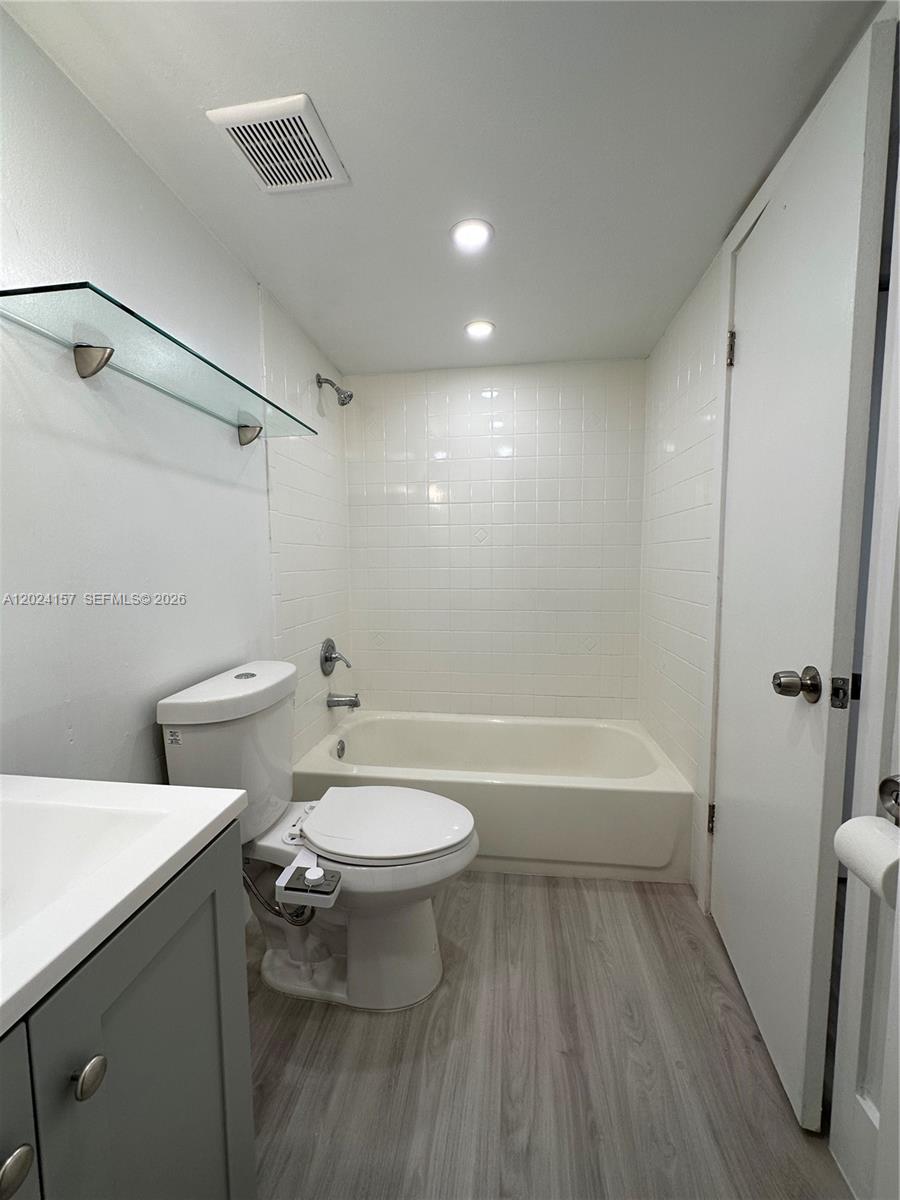 A bathroom features a gray vanity, a white toilet with a bidet, and a tub-shower — 10813 NW 7th St # 11, Miami FL 33172, MIAMI, FL