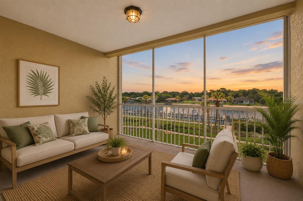 A screened-in balcony features patio furniture, a rug, and a view of a waterfront sunset — 700 CANOPY WALK LANE UNIT 734, PALM COAST, FL