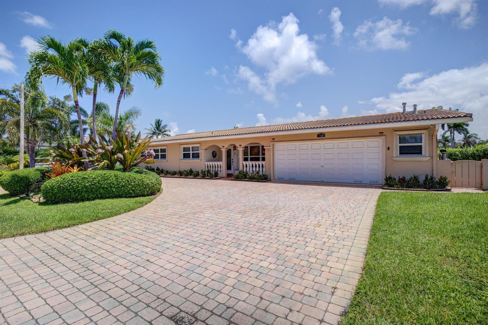 A single-story house with a beige exterior, a tiled roof, and a paved driveway — 1920 Waters Edge, Pompano Beach FL 33062, POMPANO BEACH, FL
