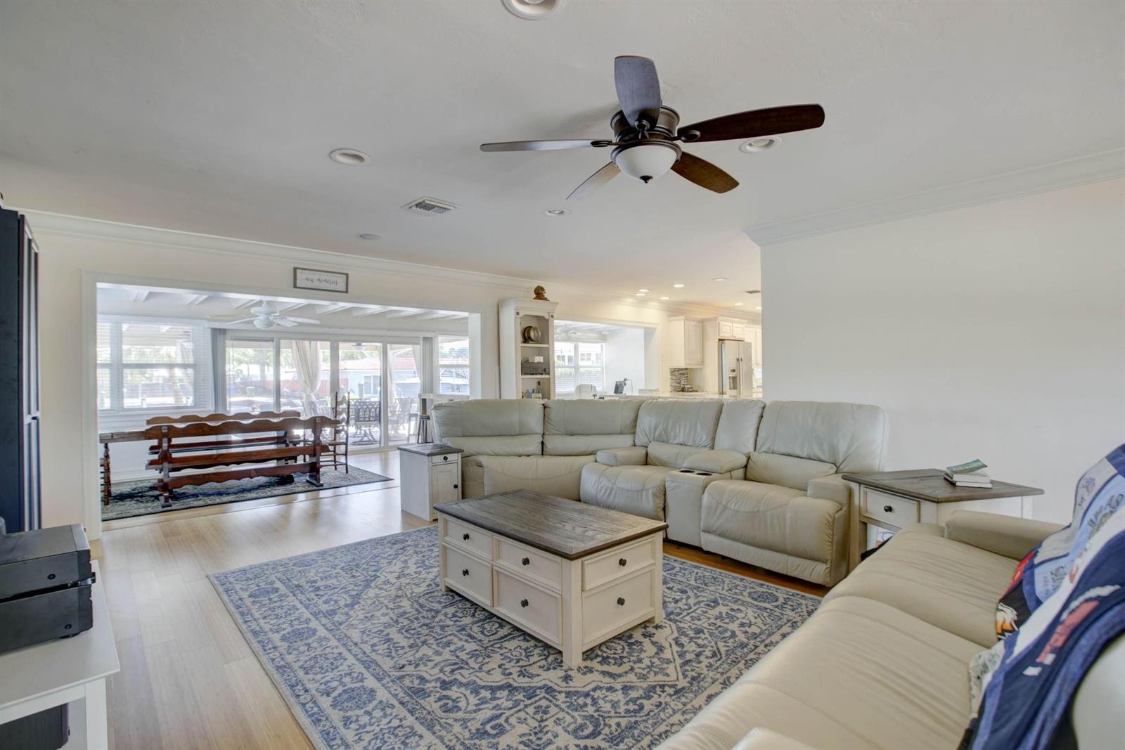 A living room with a large sectional sofa, a coffee table, and a ceiling fan — 1920 Waters Edge, Pompano Beach FL 33062, POMPANO BEACH, FL