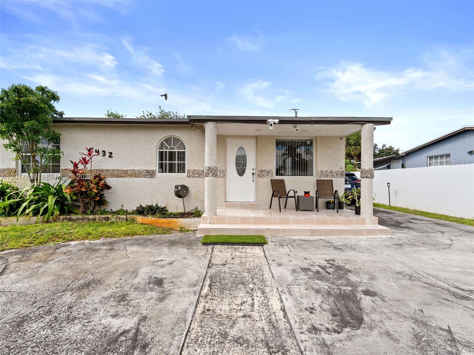 A single-story house features a concrete driveway, a covered front porch, and stucco exterior walls — 6432 Perry St, Hollywood FL 33024, HOLLYWOOD, FL