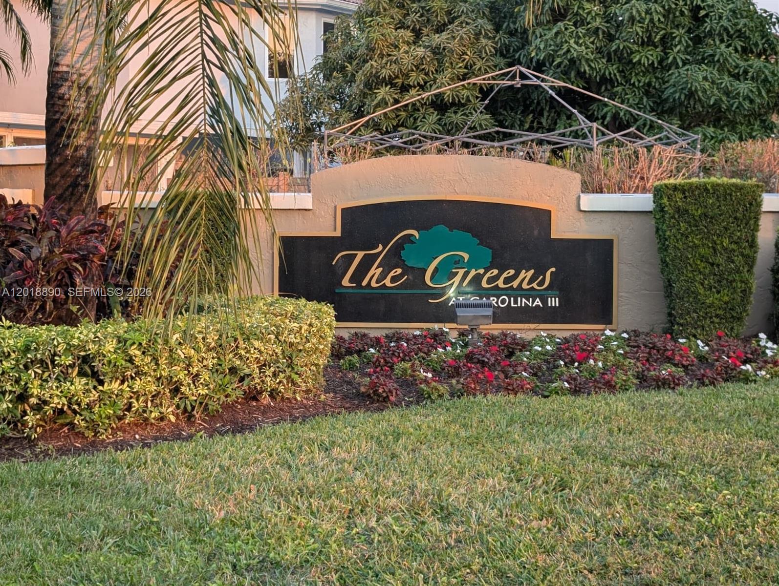 A sign for The Greens at Carolina III stands in a landscaped garden area — 2608 NW 79th Ave, Margate FL 33063, MARGATE, FL