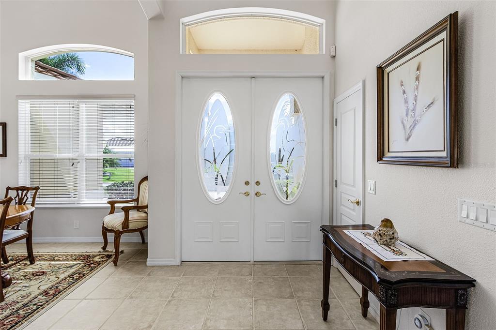 An entryway features tiled floors, a double front door with oval glass inserts, and furniture — 400 GUN CAY LANE, PUNTA GORDA, FL