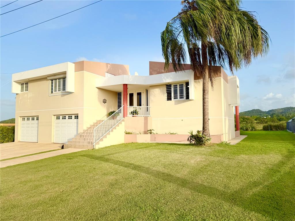 An exterior view of a two-story house with a two-car garage and a front staircase — Urb. La Romana 216 CALLE FRANCHESCO, QUEBRADILLAS, PR