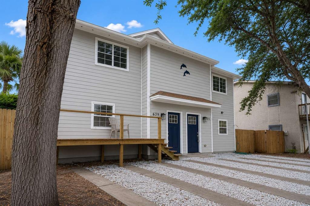 A two-story light gray house with two blue front doors and a wooden deck — 635 6TH AVENUE S, JACKSONVILLE BEACH, FL
