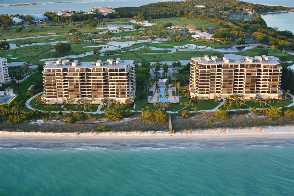 An aerial view of two beachfront condominium buildings situated next to a golf course — 435 L AMBIANCE DRIVE UNIT L807, LONGBOAT KEY, FL