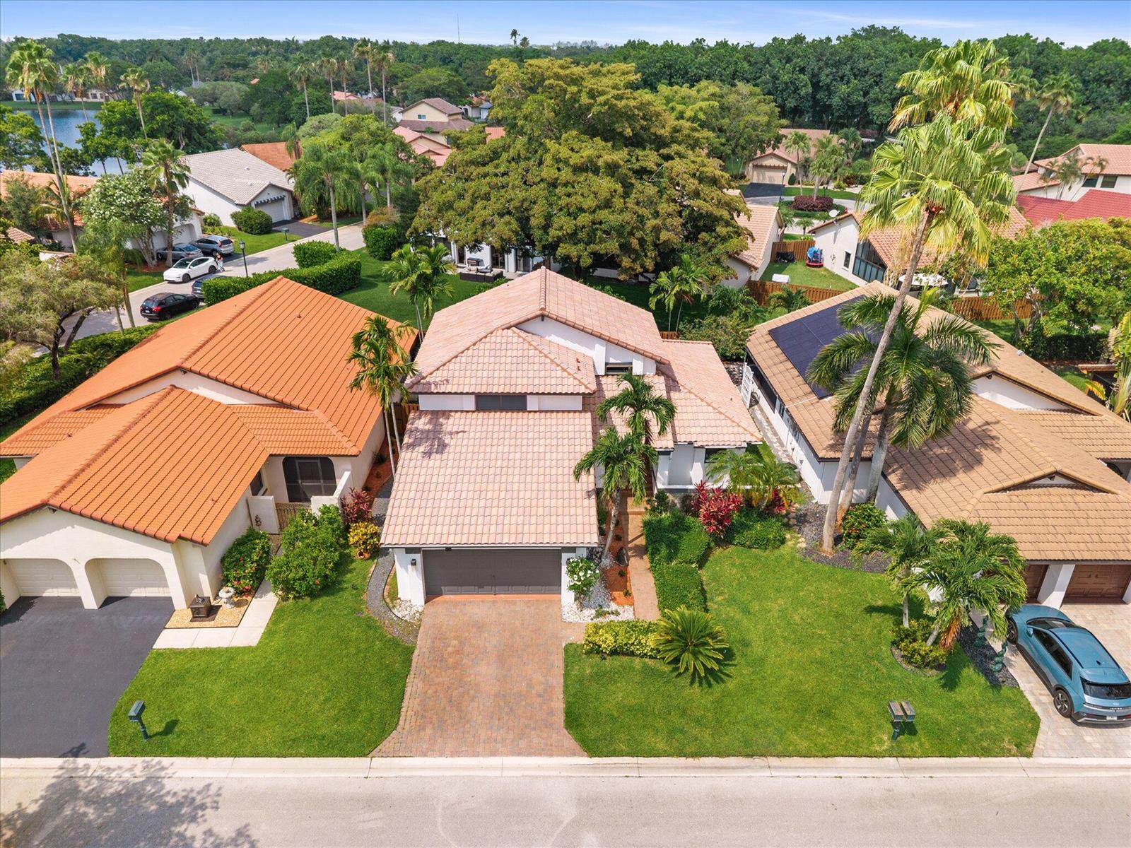 An aerial view of a suburban house with a tiled roof and a paved driveway — 2116 Austin, Weston FL 33326, WESTON, FL