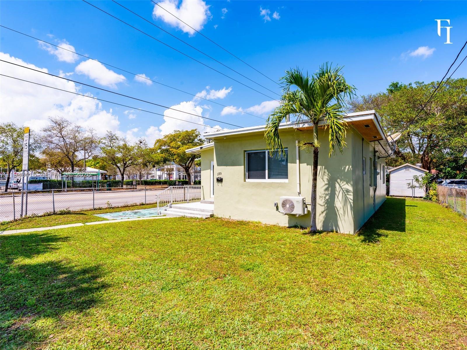 A light green, single-story house with a palm tree and a window-mounted air conditioning unit — 1195 NW 48th St, Miami FL 33127, MIAMI, FL