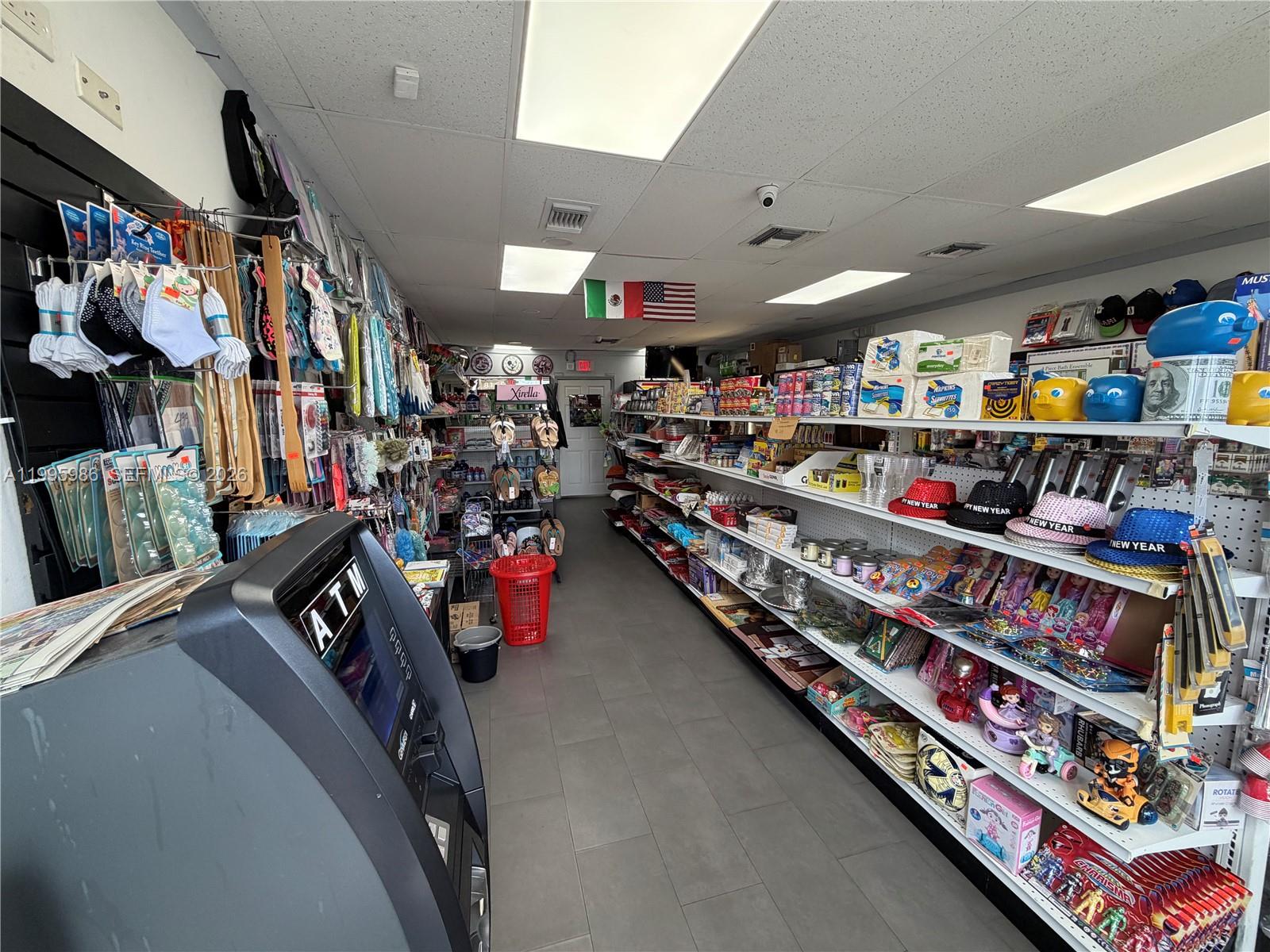 This retail store interior features an ATM, long shelving units, and various merchandise for sale — GROCERY STORE FOR SALE, Miami FL 33155, MIAMI, FL