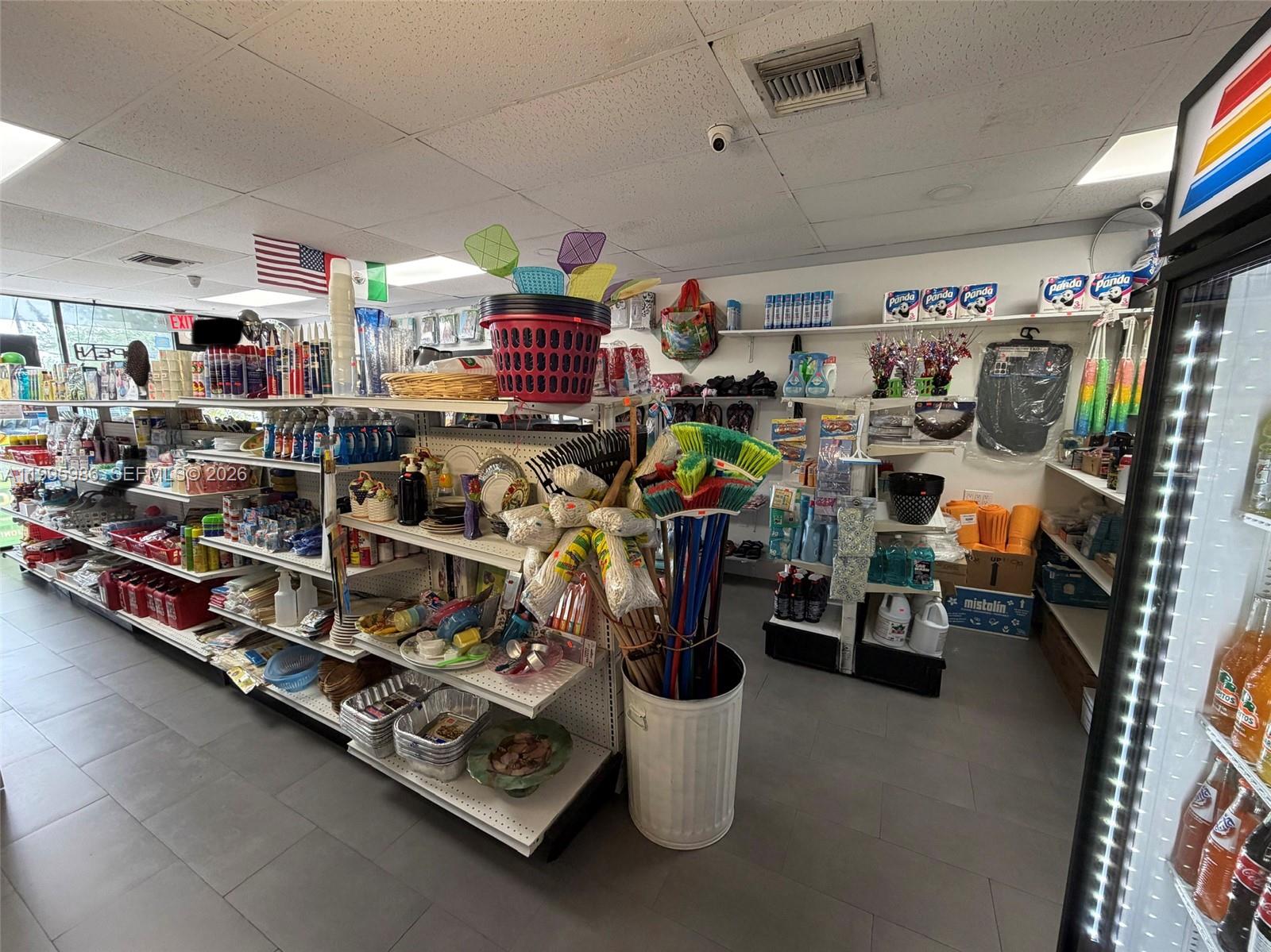 A retail store interior features shelves stocked with various household cleaning supplies and goods — GROCERY STORE FOR SALE, Miami FL 33155, MIAMI, FL