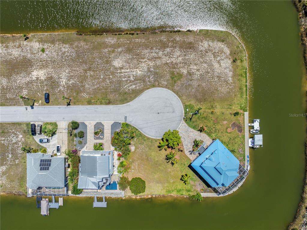 An aerial view shows two houses on a waterfront lot at the end of a cul-de-sac — 3336 CROAKER DRIVE Lot 36, HERNANDO BEACH, FL