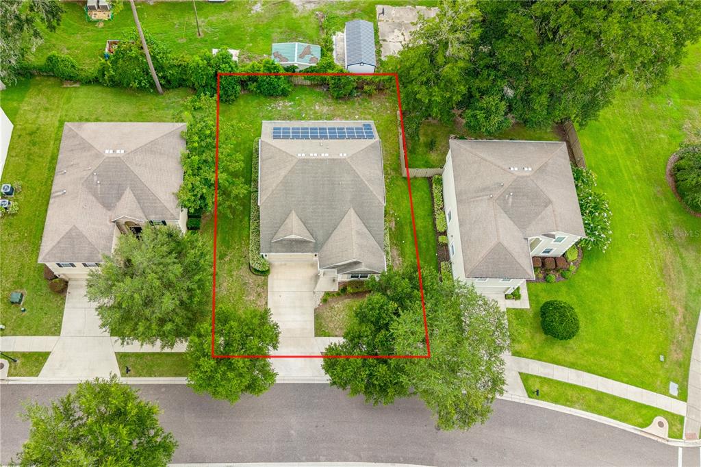 An aerial view shows a single-family house with solar panels on the roof — 14369 NW 159TH PLACE, ALACHUA, FL