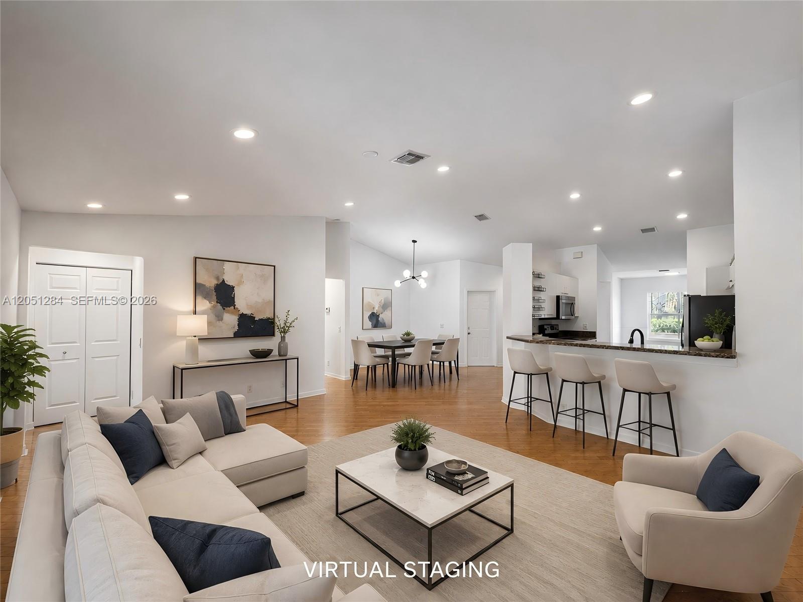 A living room, dining area, and kitchen with hardwood floors and virtual staging furniture — 2082 Borealis Way, Weston FL 33327, WESTON, FL