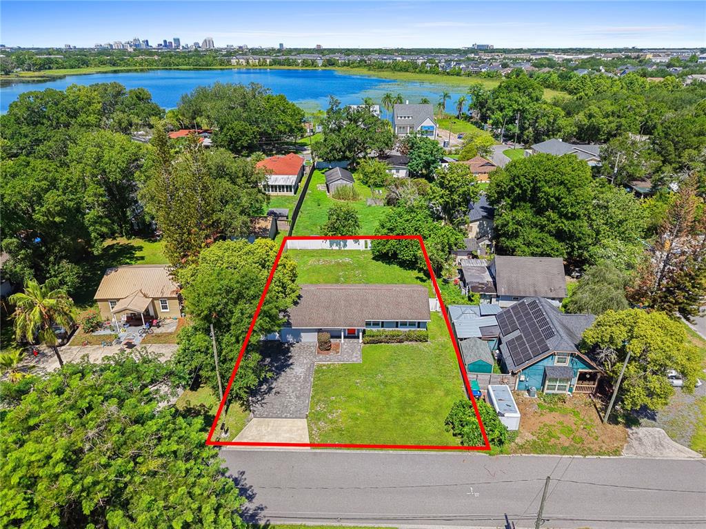 An aerial view shows a single-story house with a paved driveway and a large yard — 1350 SASOON AVENUE, ORLANDO, FL