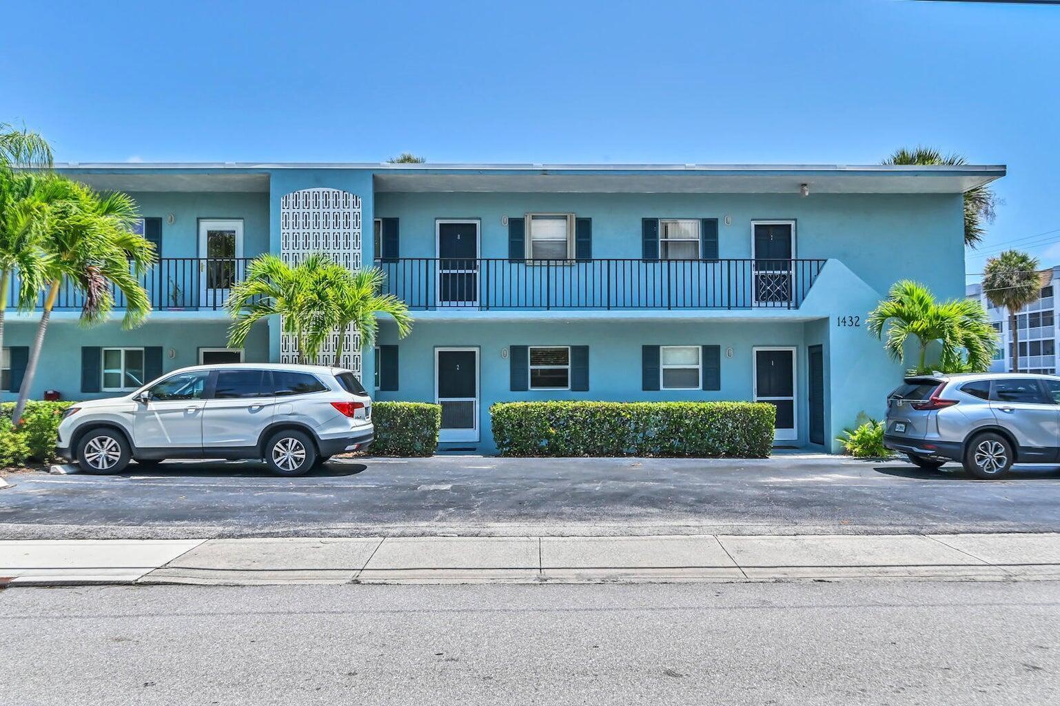 A two-story blue apartment building with a parking lot and two parked SUVs — 1432 S Lakeside Drive # 2, FL 33460, FL