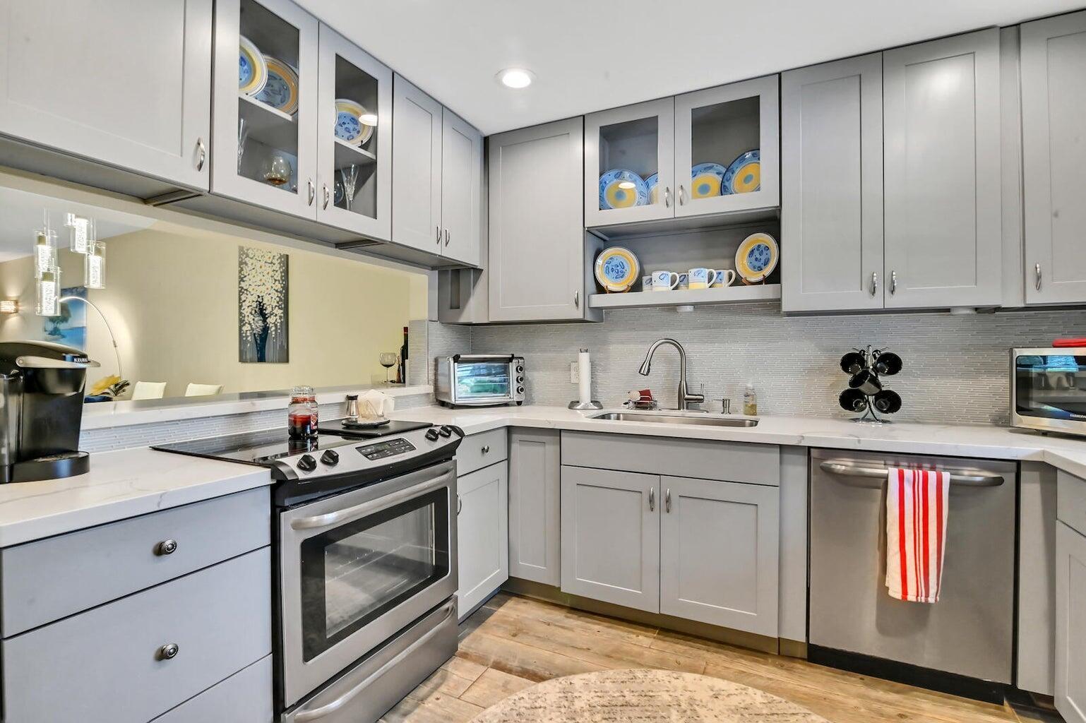 A kitchen with grey cabinets, stainless steel appliances, and a light-colored tile backsplash — 1432 S Lakeside Drive # 2, FL 33460, FL