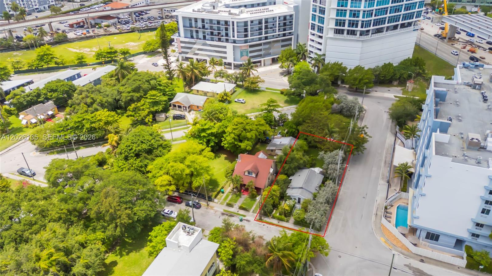 An aerial view shows a residential lot outlined in red next to a large apartment building — 1246 NW 9th Ave, Miami FL 33136, MIAMI, FL