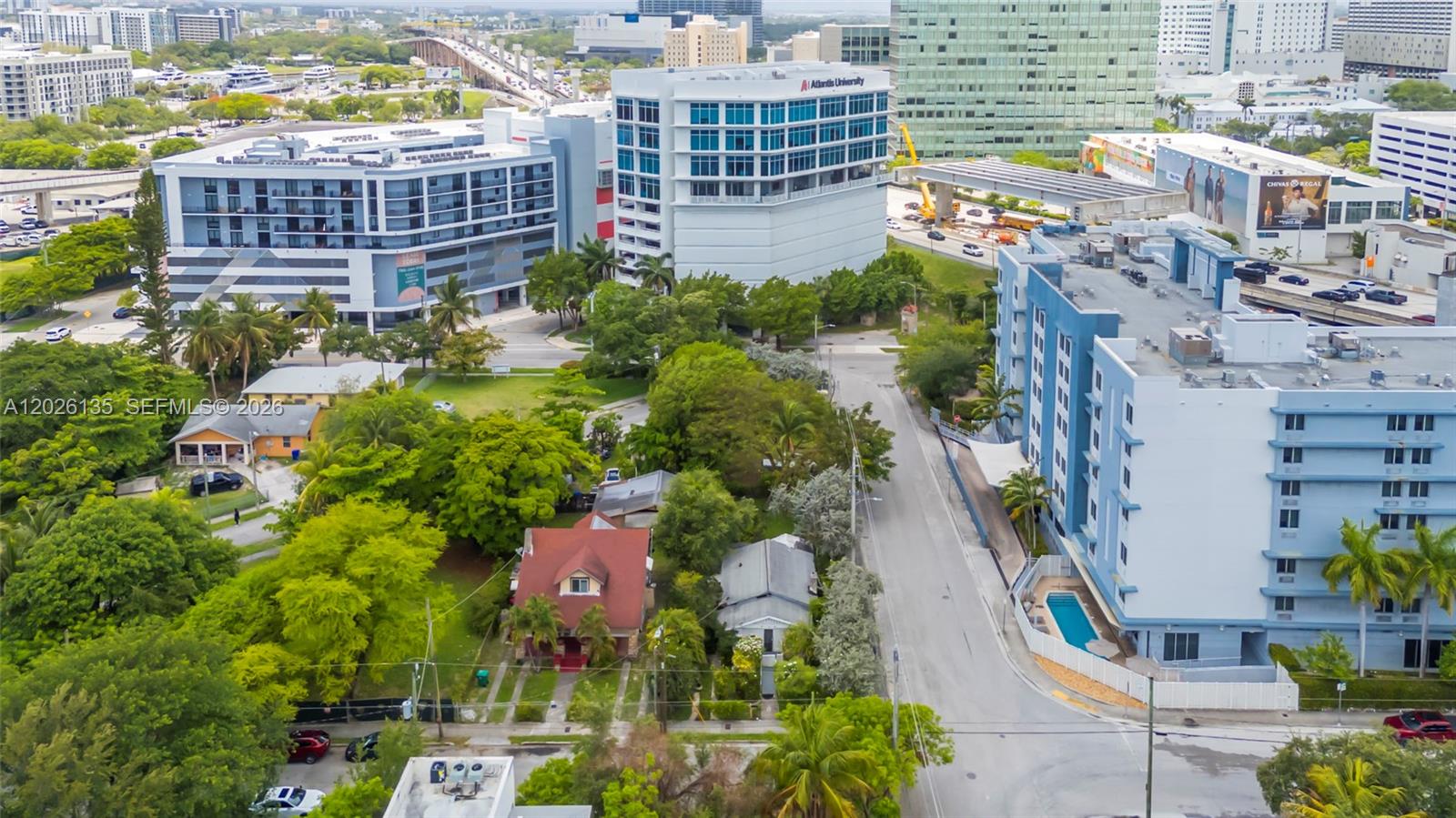 An aerial view shows a residential street with houses nestled among taller commercial buildings — 1246 NW 9th Ave, Miami FL 33136, MIAMI, FL