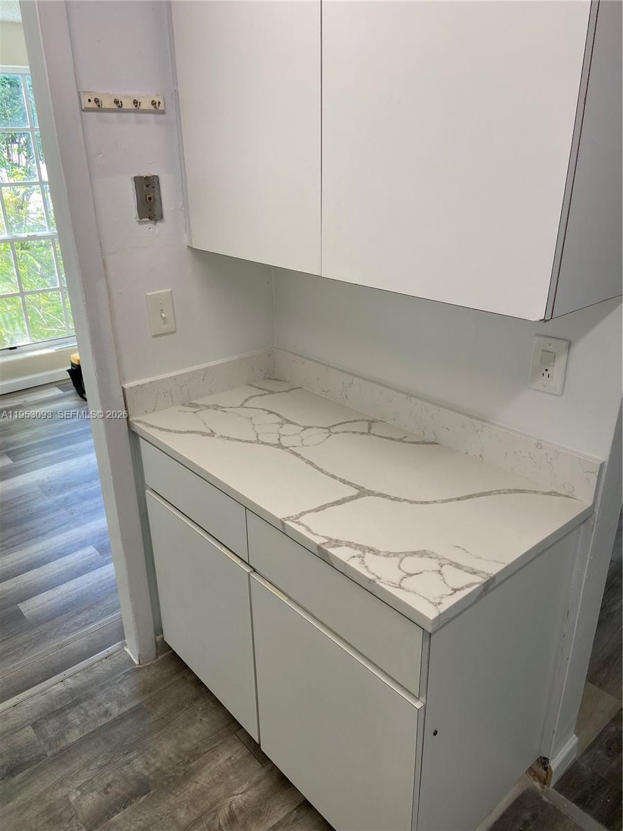 A kitchen area features white cabinets, a marble-patterned countertop, and a backsplash — 9503 SW 88th Ter # 9503, Miami FL 33176, MIAMI, FL