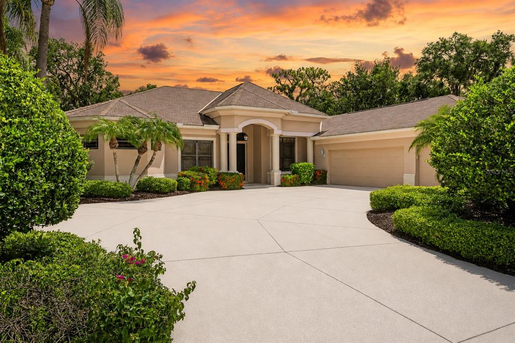 A single-story house with a beige stucco exterior, a multi-car garage, and a concrete driveway — 2339 LITTLE COUNTRY ROAD, PARRISH, FL