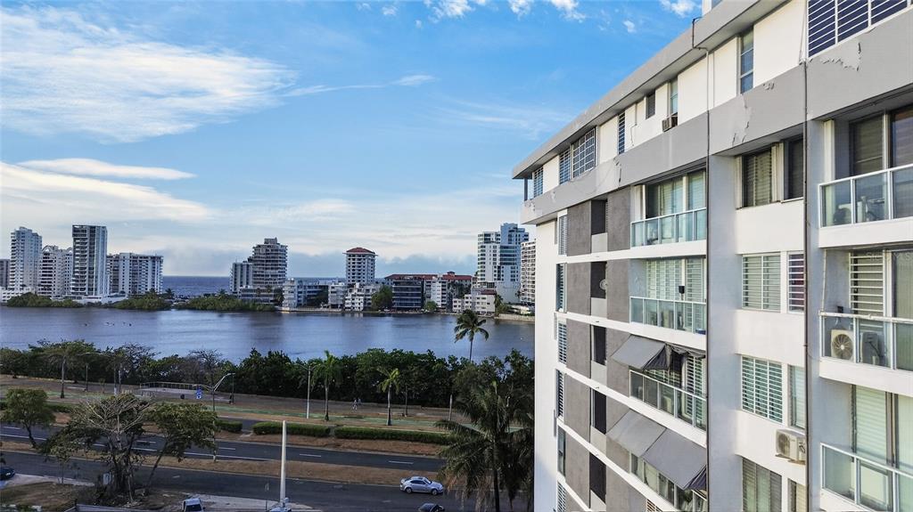 A high-angle view of a coastal apartment building overlooking a bay and city skyline — 501 ELISA COLBERG, MIRAMAR Apt 4-E, SAN JUAN, PR
