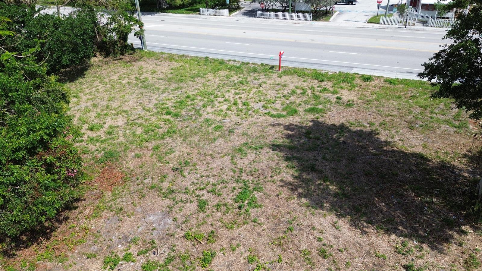 An aerial view of a vacant, grassy lot situated next to a paved road — 2944 Westgate Avenue, West Palm Beach FL 33409, WEST PALM BEACH, FL
