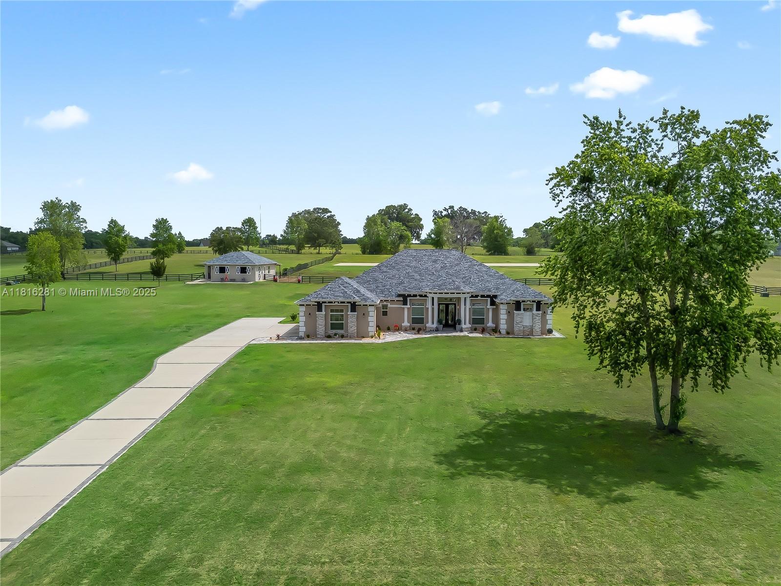 An aerial view shows a single-story house with a driveway and a detached garage — 7161 NE 22nd Ct Rd, Ocala FL 34479, OCALA, FL