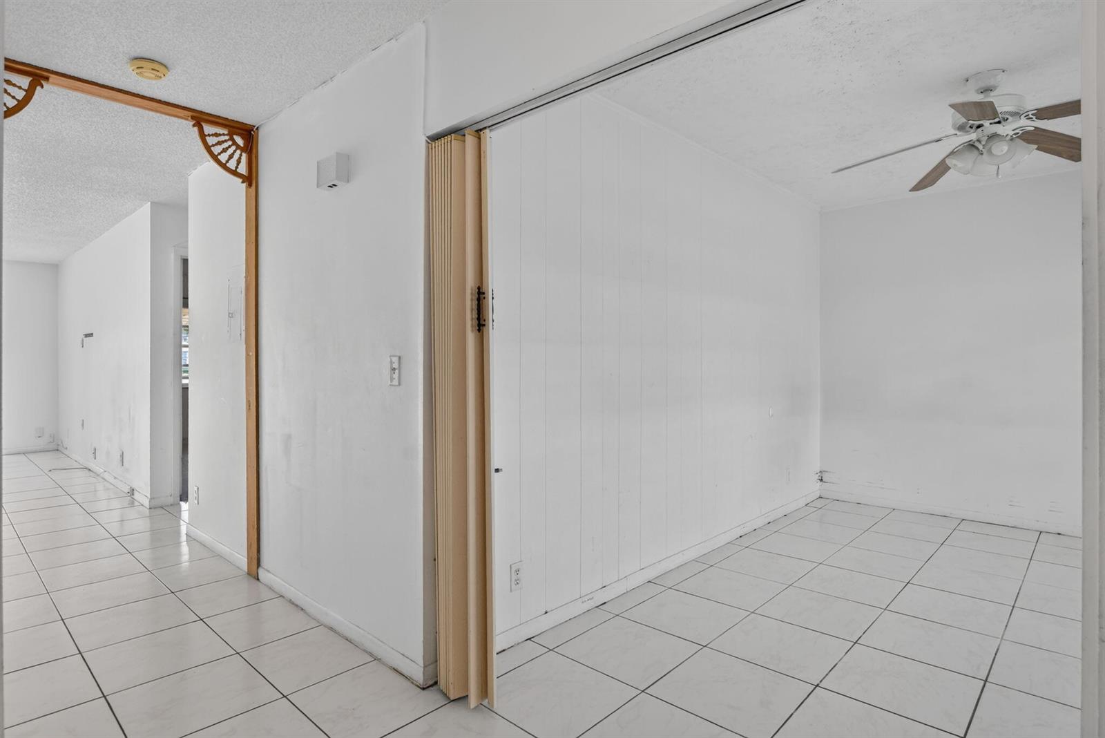 A room with white tile floors, a ceiling fan, and a folding accordion door — 20923 Sedgewick Drive # 386, Boca Raton FL 33433, BOCA RATON, FL