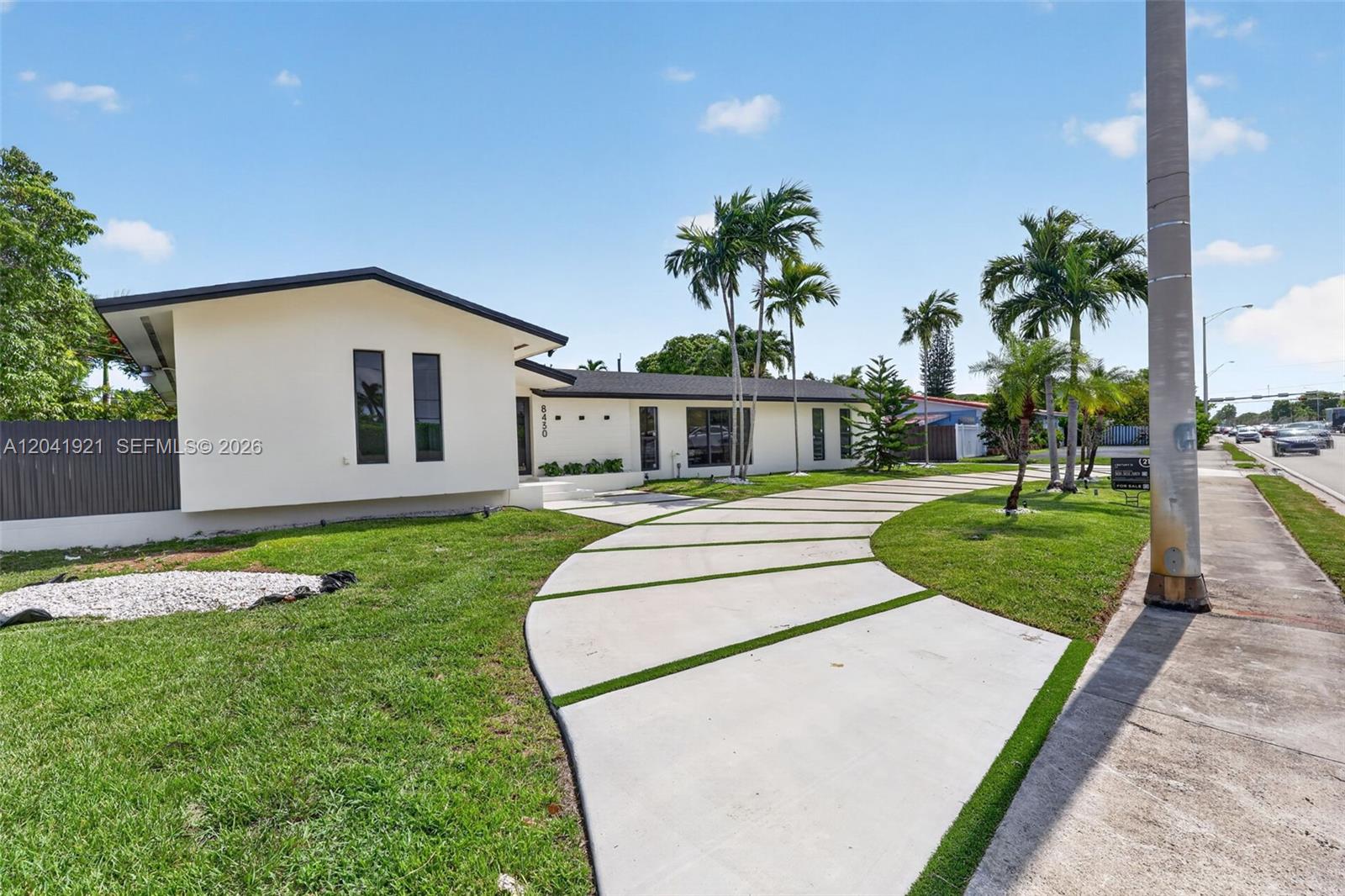 A single-story house with a curved concrete driveway and palm trees in the front yard — 8430 SW 88th St, Miami FL 33156, MIAMI, FL