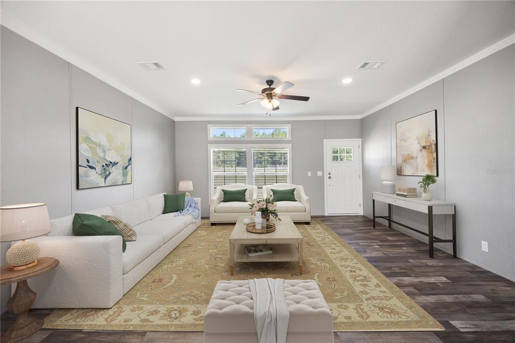 A living room features a white sofa, two armchairs, a coffee table, and wood-look flooring — 2362 NE COUNTY ROAD 1469, HAWTHORNE, FL