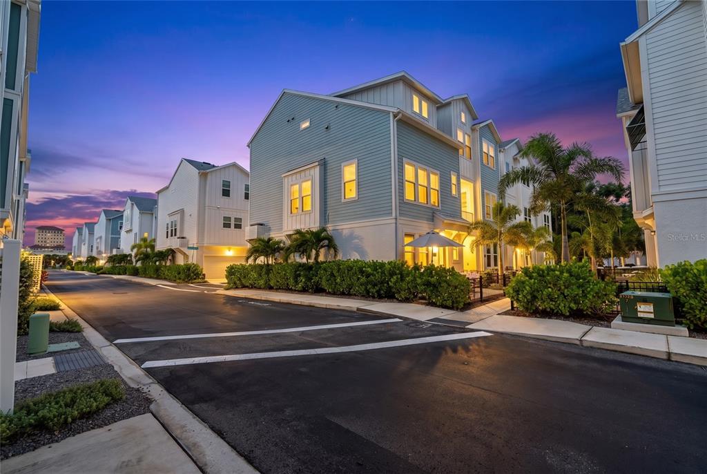 A living room features a wall-mounted television, a media console, and stairs leading upward — 2501 BOONE COURT, SARASOTA, FL