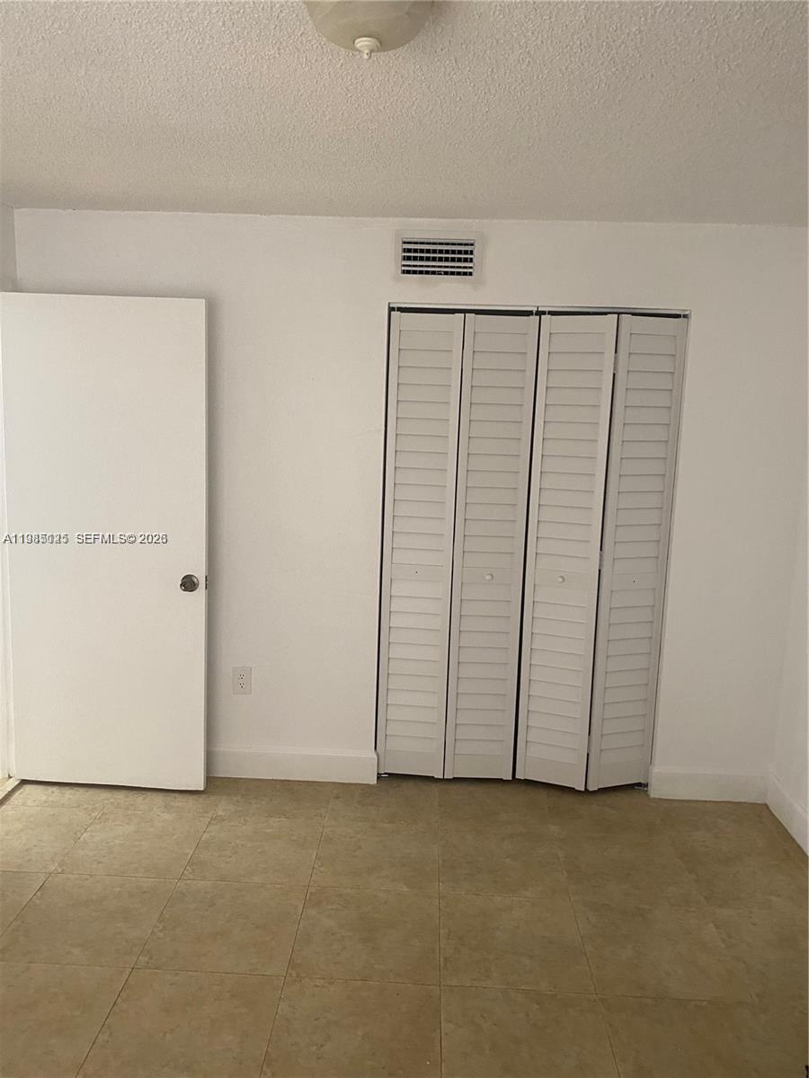 A two-story peach-colored apartment building with brown shutters and a tiled roof — 7201 Miami Lakes Dr # B14, Miami Lakes FL 33014, MIAMI LAKES, FL