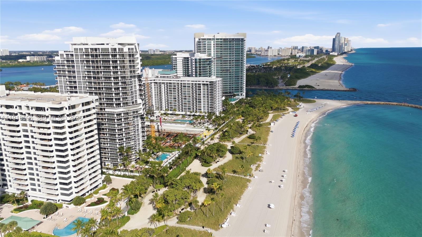 An aerial view shows high-rise residential buildings situated along a sandy beach and ocean — 10275 Collins Avenue # 1101, Bal Harbour FL 33154, BAL HARBOUR, FL