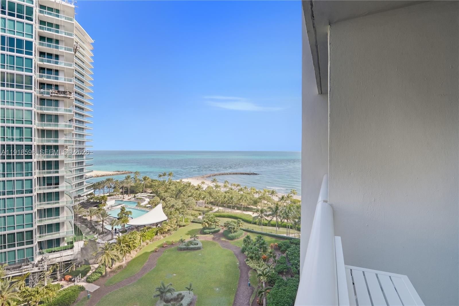 A balcony view overlooks a park, a swimming pool, and the ocean — 10275 Collins Avenue # 1101, Bal Harbour FL 33154, BAL HARBOUR, FL